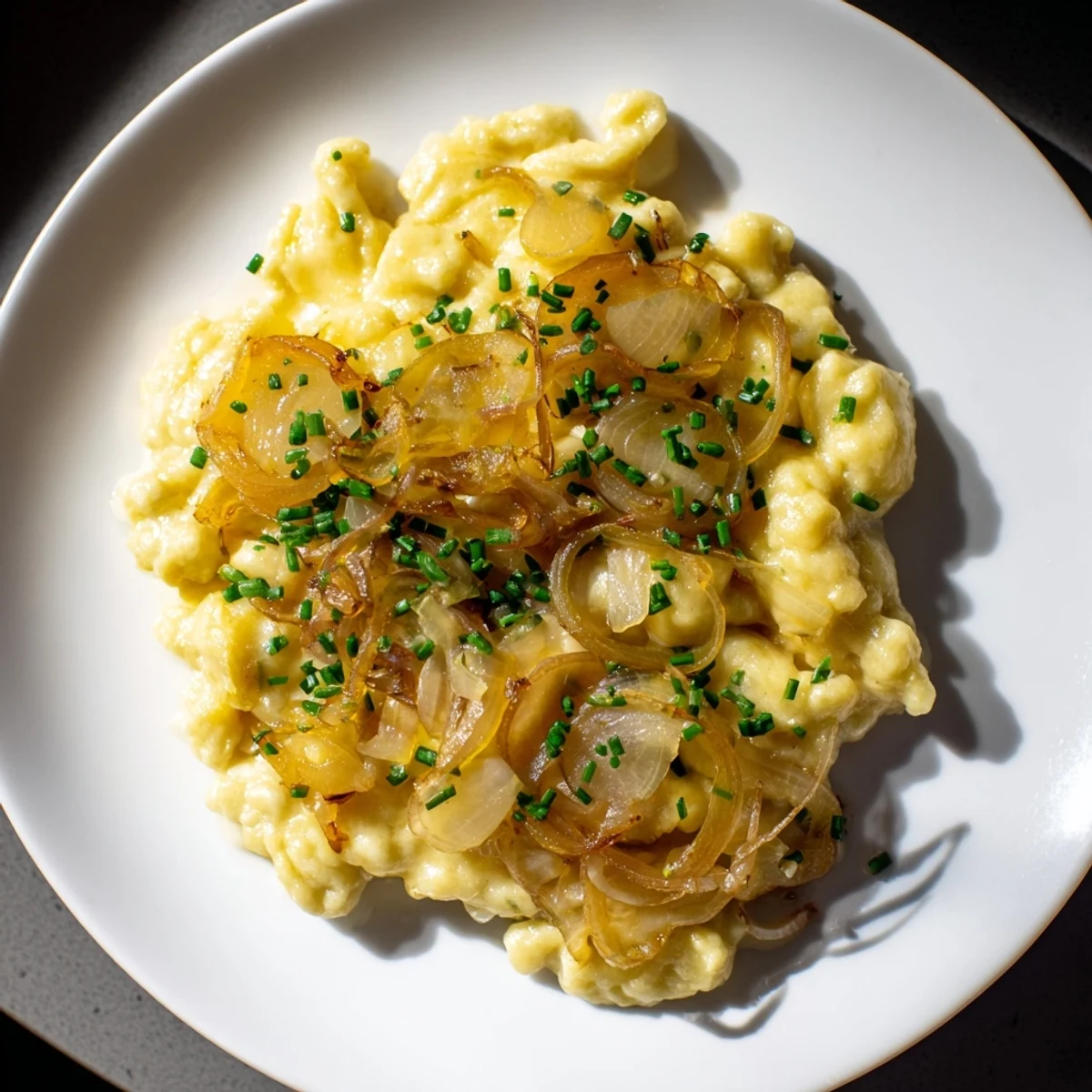 This comforting Käsespätzle features homemade spaetzle layered with gooey, delicious cheese and onions.