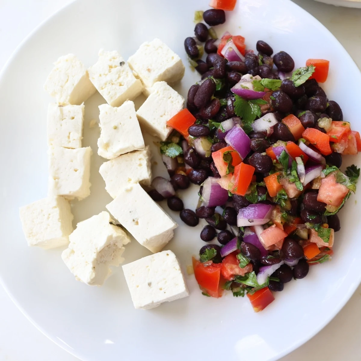 Fresh Pepper Jack cheese cubes alongside vibrant black bean salsa, perfect for any savory bites appetizer.