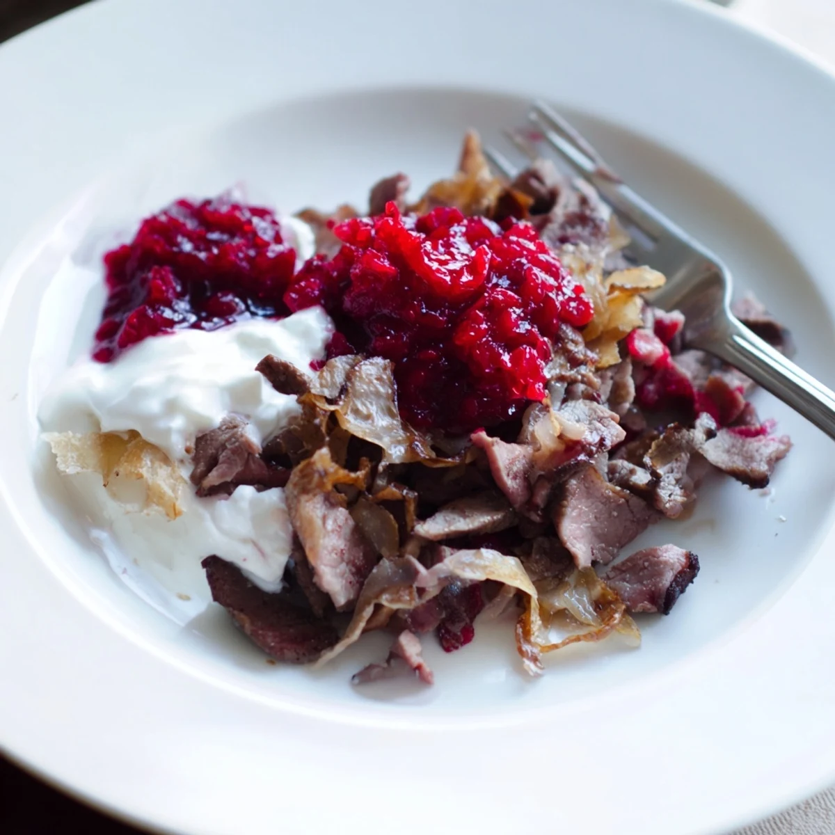 Slow-cooked Finnish Reindeer Stew, imagine the tender meat and rich gravy, served with mashed potatoes.