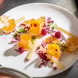 Baisers de Minuit: A festive arrangement including sugared orange slices and glistening edible glitter.