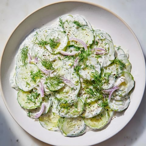 Creamy Omas German Cucumber Salad, with fresh dill, ready to eat, a perfect side dish.
