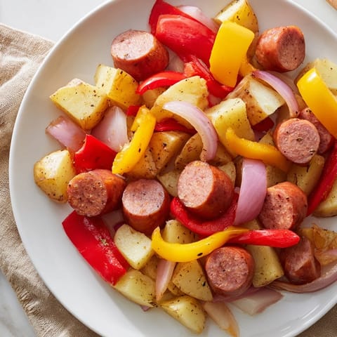 One-pot kielbasa and potato bake, with beautifully browned sausage and vegetables in a savory pot.